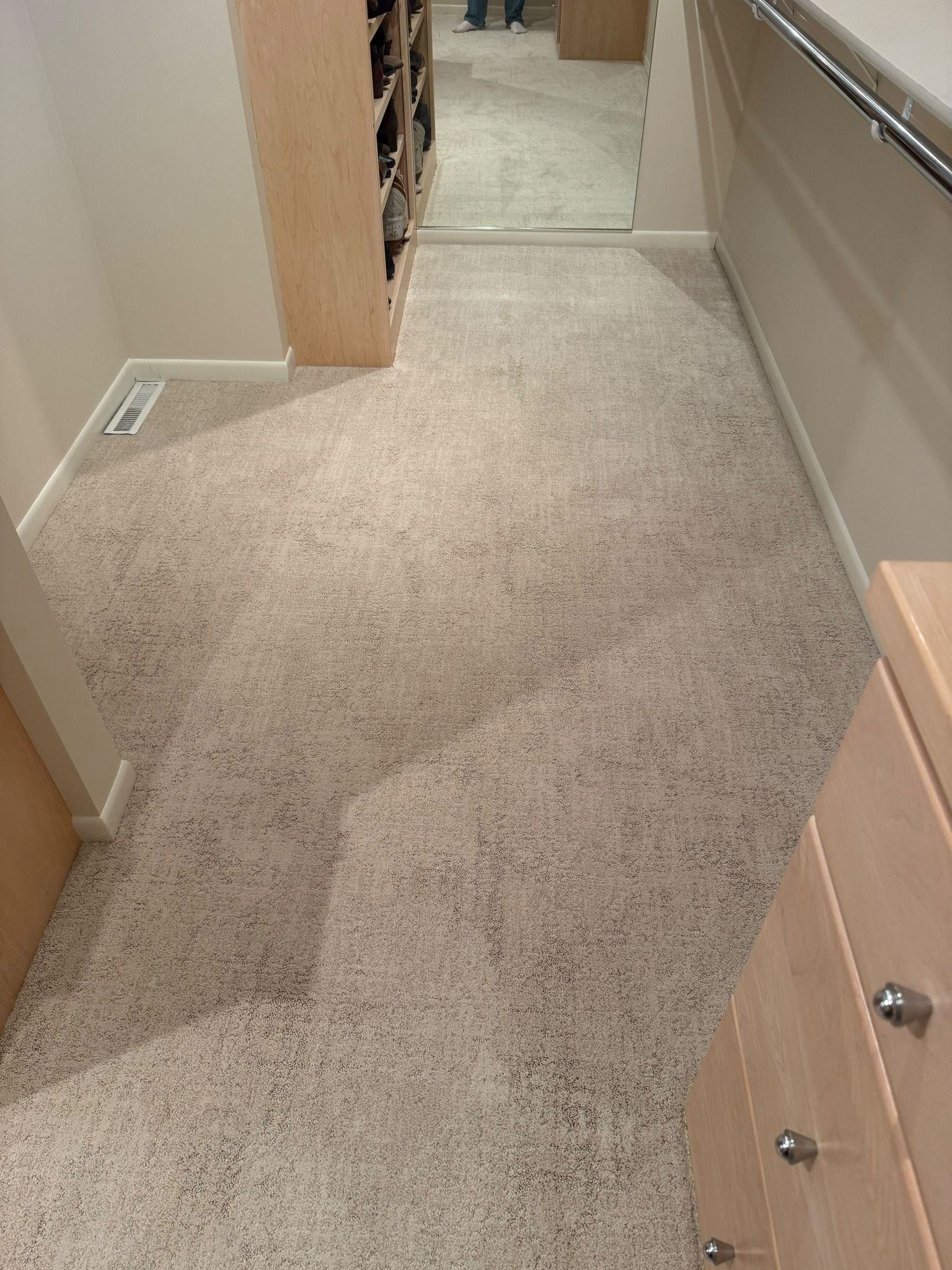 Newly installed light beige carpet in a hallway leading to other rooms.